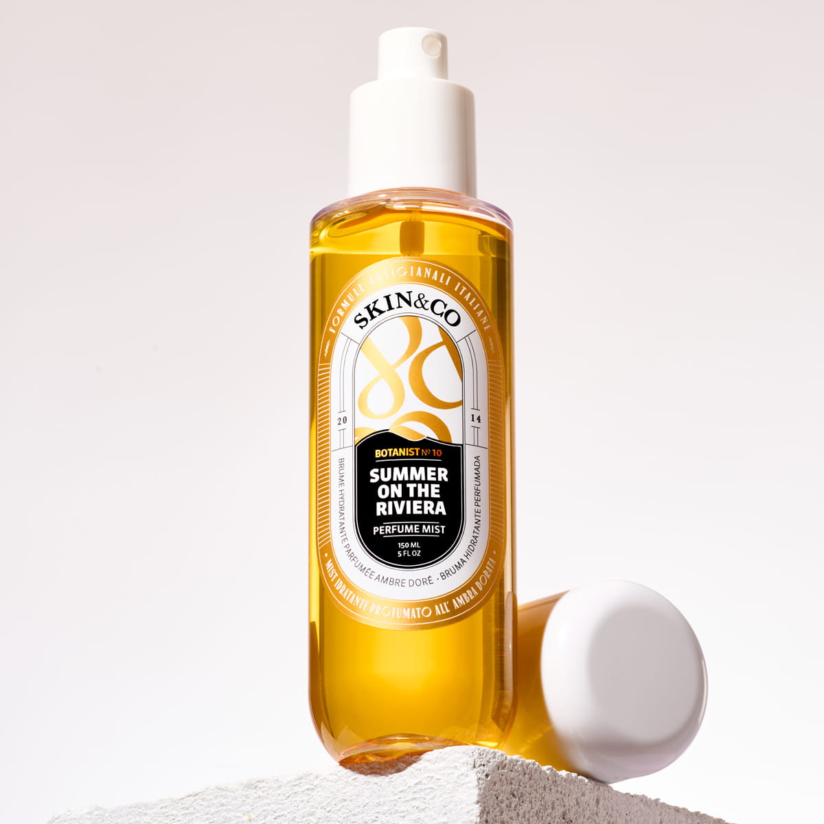 Lifestyle shot of Skin & Co Summer On the Riviera Perfume Mist (150 ml) show with cap off