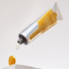 Lifestyle shot of Skin & Co Citrus Amaro Hand Cream (30 ml) with cap off and cream dispensed from tube