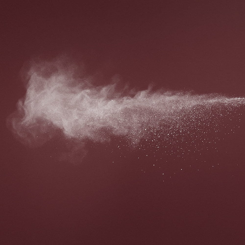 Cleo+Coco Body & Hair Powder - Grapefruit Bergamot (25 g) - product shown being sprayed. 