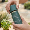 Cleo+Coco Extra Strength Deodorant - Basil Mint (62 g) - model holding product outdoors. 