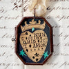 Maris Mirum Small Locket - Nunc Scio Ii. with vintage paper with script handwriting in the background.