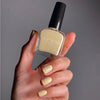Karolin Van Loon Nail Polish - 52 Beurre Soleil (15 ml) - product shown being held by model. 