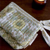 Paper Mirchi Organic Cotton Pouch Set - Floral Buttercream (2 pcs) - product shown on wooden counter. 
