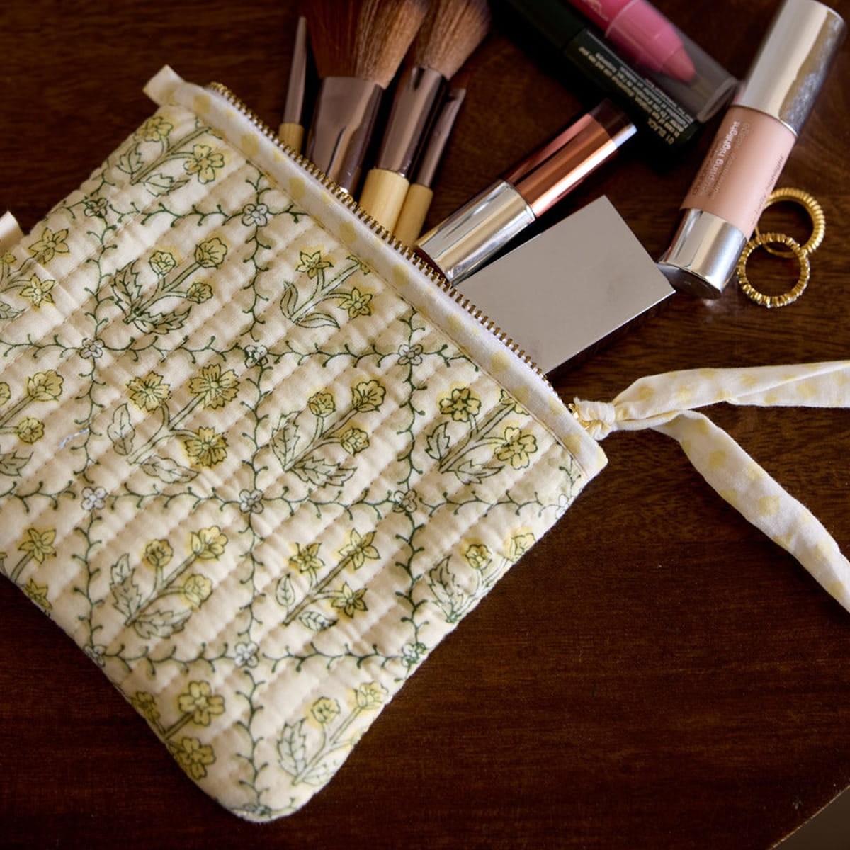 Paper Mirchi Organic Cotton Pouch Set - Floral Buttercream (2 pcs) - product shown on wooden counter. 
