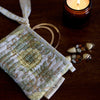 Paper Mirchi Organic Cotton Pouch Set - Floral Buttercream (2 pcs) - product shown on wooden counter. 