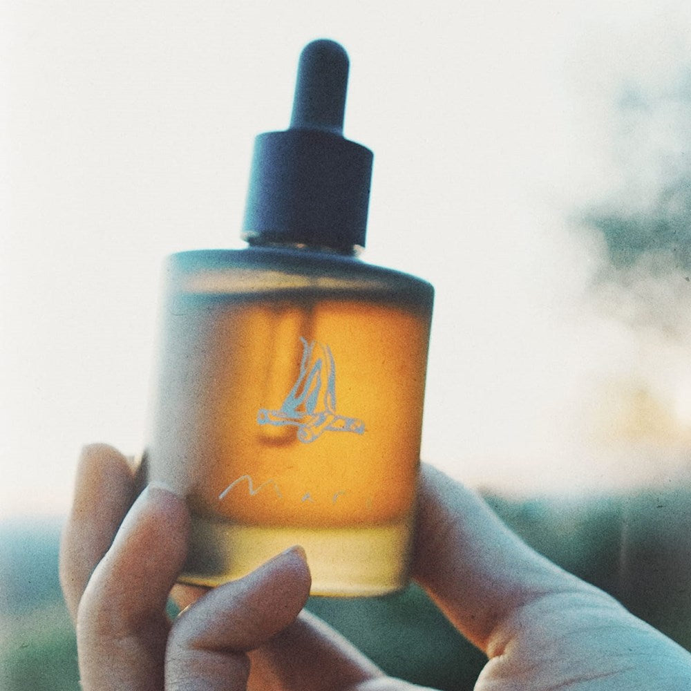 Close up of person holding Mari St. Lucia Body Oil (50 ml)