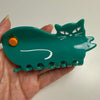 Centinelle Orange Green Cat Hair Claw (1 pc) - product shown being held. 