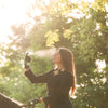 Good Psyche Glisten Up! Hydro Boosting Facial Mist (100 ml) - product shown being sprayed on women. 