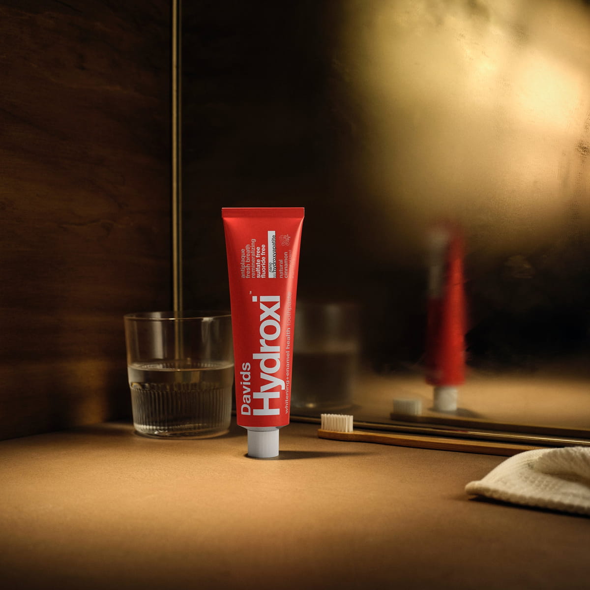 Davids Hydroxi Whitening + Enamel Health Toothpaste – Cinnamon (4 oz) - product shown on bathroom counter.