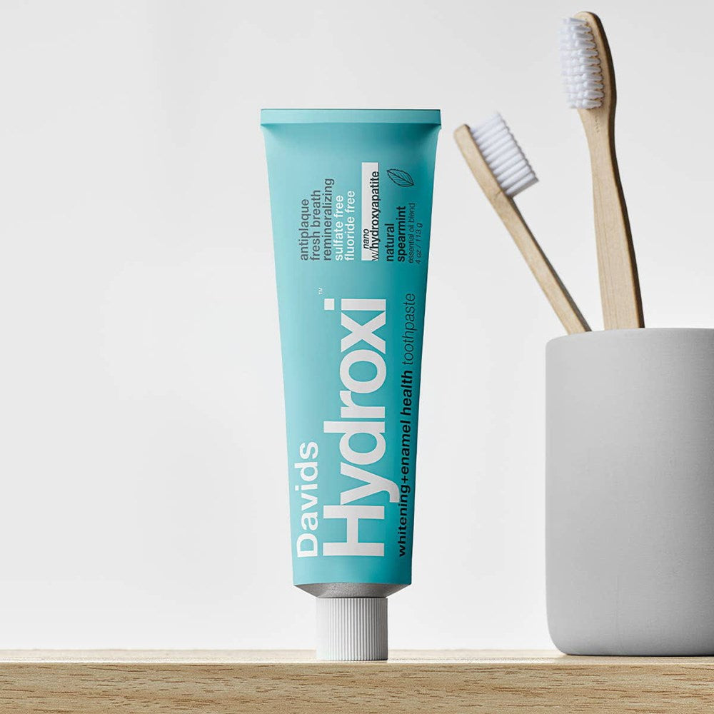Davids Hydroxi Whitening + Enamel Health Toothpaste – Spearmint (4 oz) - product shown on bathroom counter. 