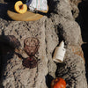 See You Sundae Gradual Tanning Body Butter (300 ml) - product shown on rocks. 