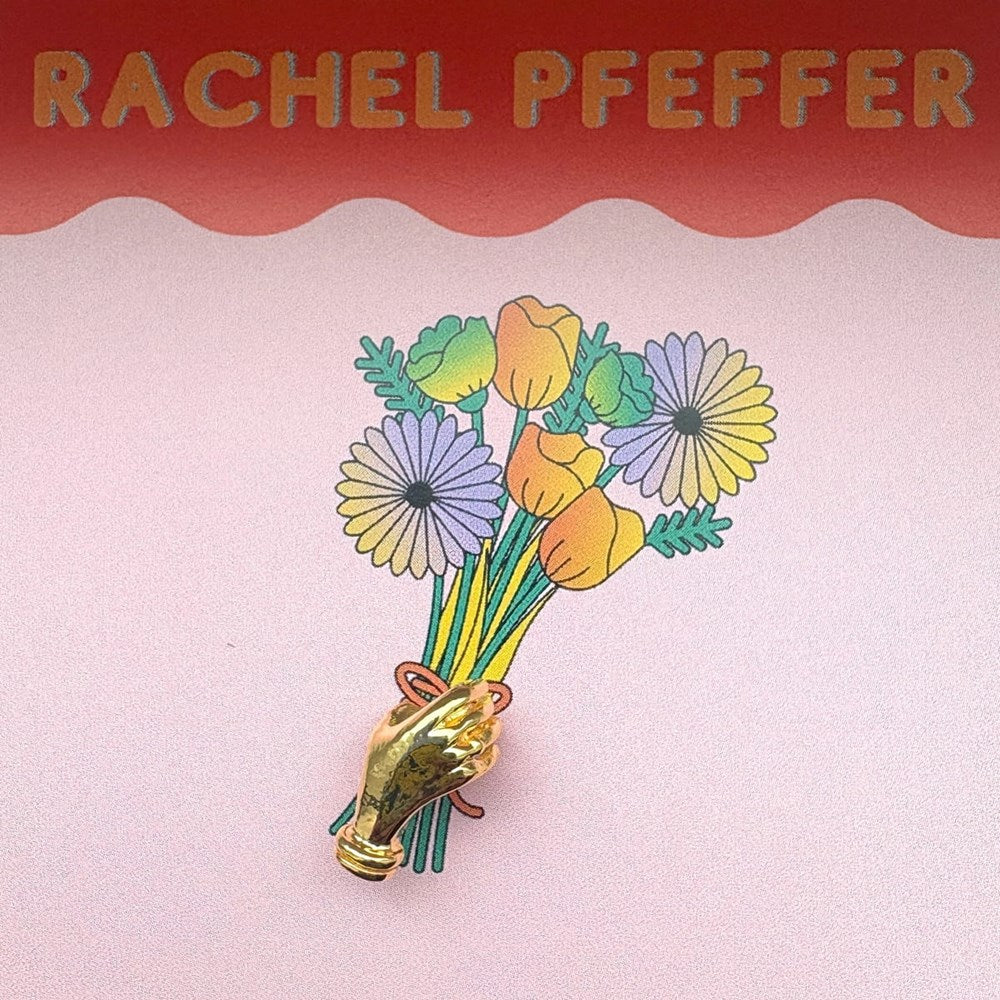 Rachel Pfeffer A Hand Holding Flower Lapel Pin - Brass (1 pc) - product shown in packaging.