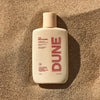DUNE Suncare The Mug Guard (72 ml) - product shown on sand.