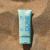 DUNE Suncare The Mineral Melt (50 ml) - product shown on sand.