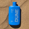 DUNE Suncare The Bod Guard (250 ml) - product shown in sand. 