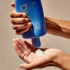 DUNE Suncare The Bod Guard (250 ml) - product shown being squeezed into hand. 