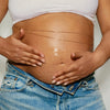 DUNE Suncare The Bod Guard (250 ml) - product shown being applied to a stomach.