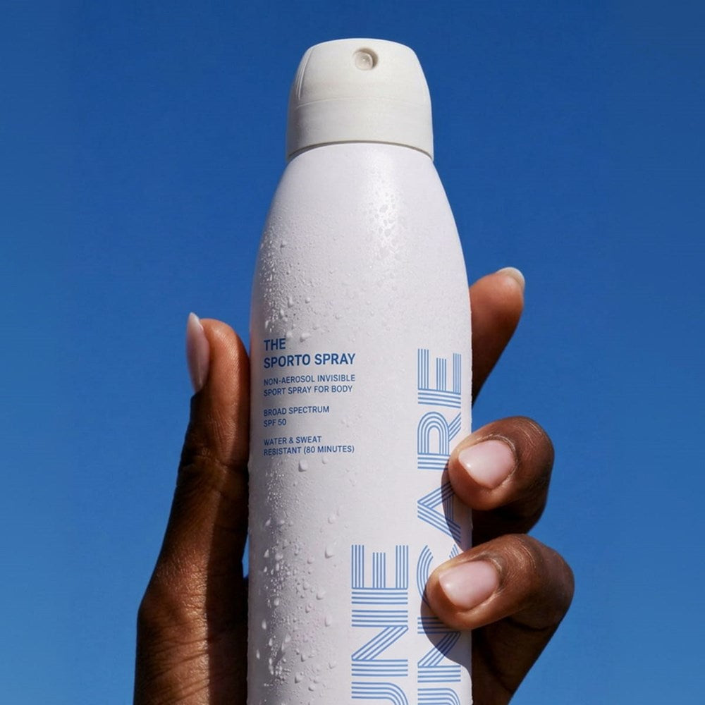 DUNE Suncare The Sporto Spray (148 ml) -  against a clear blue sky.