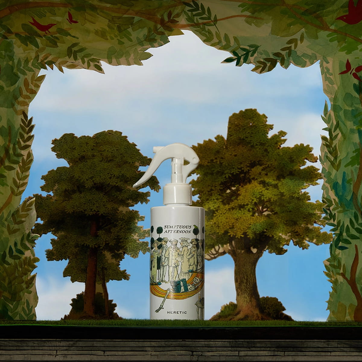 Heretic Parfum Sumptuous Afternoon Room Spray (200 ml) - product shown in front of trees and greenery.