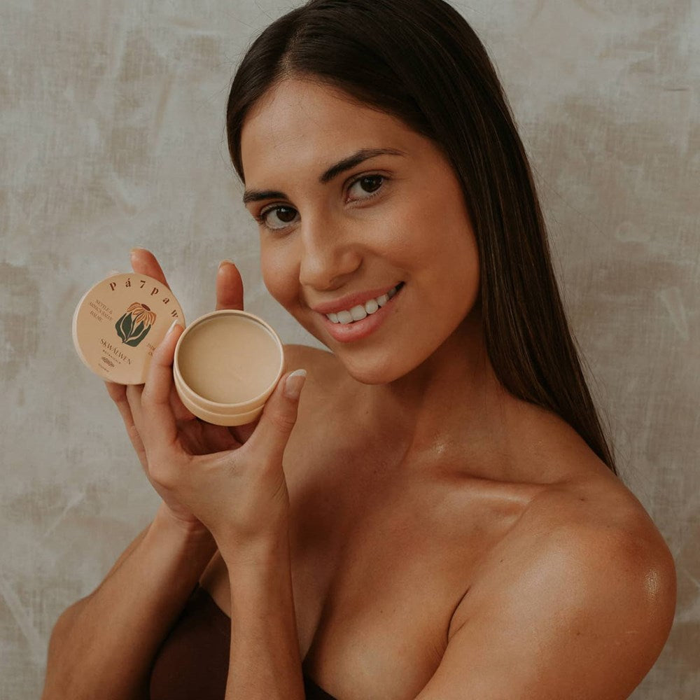 Sḵwálwen Botanicals Pá7pawtn Nettle and Arnica Salve (1.81 oz) - product shown being held by model. 
