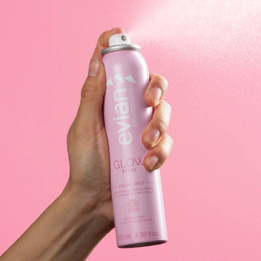 Evian Glow Facial Mist (100 ml) - product shown being sprayed.