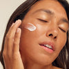 Utu Daily Face Moisturizer SPF 30 (75 ml) - product shown on models cheek.