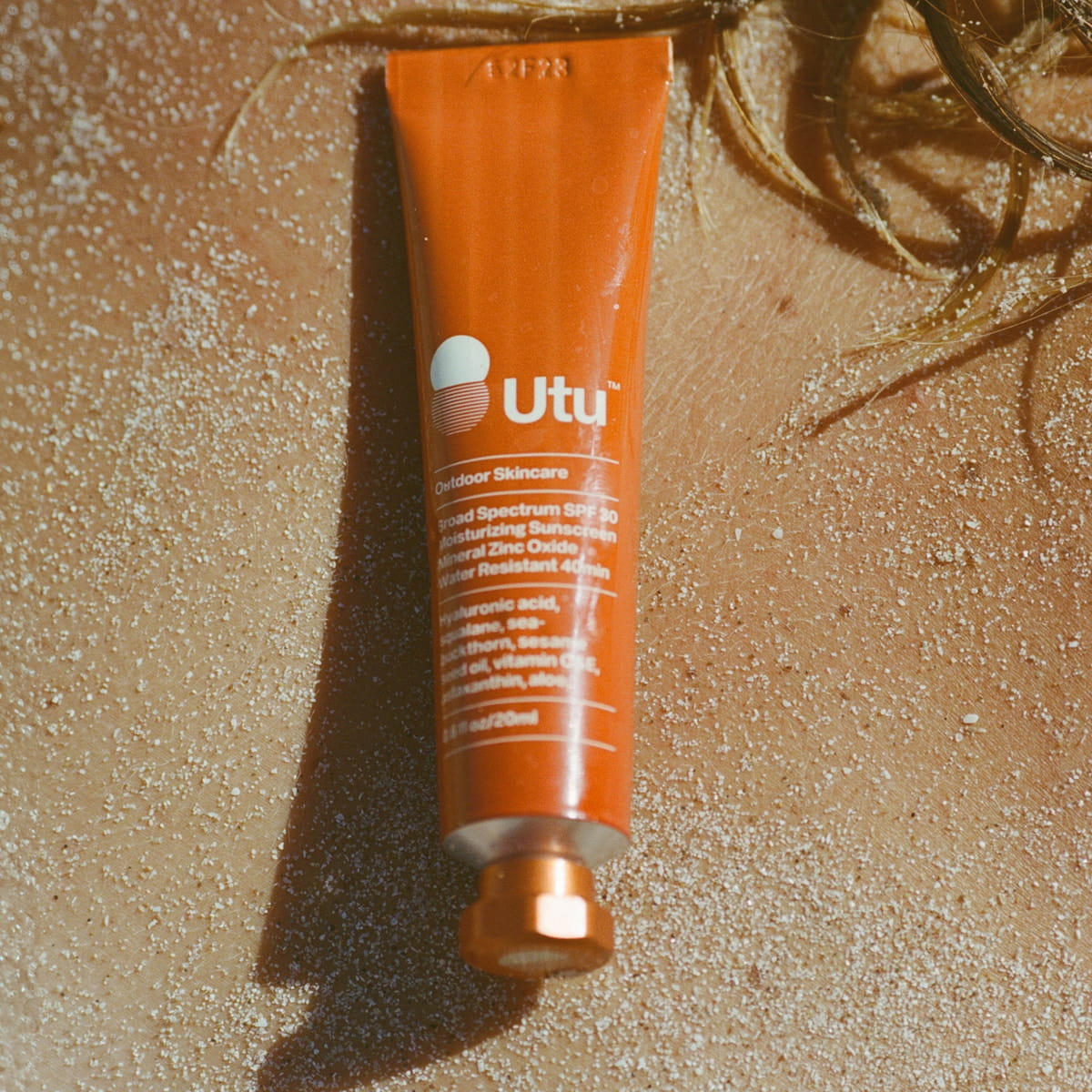 Utu Daily Face Moisturizer SPF 30 (75 ml) - product shown on sandy beach.