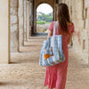 Talking Tables Recycled Plastic Croissant Tote Bag (1 pc) - product shown on women's shoulder.