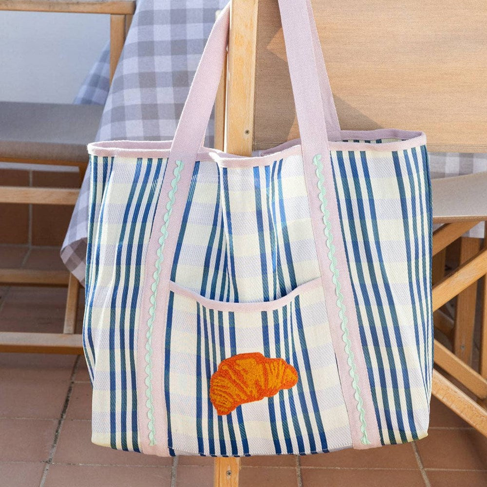 Talking Tables Recycled Plastic Croissant Tote Bag (1 pc) - product shown hanging from chair.