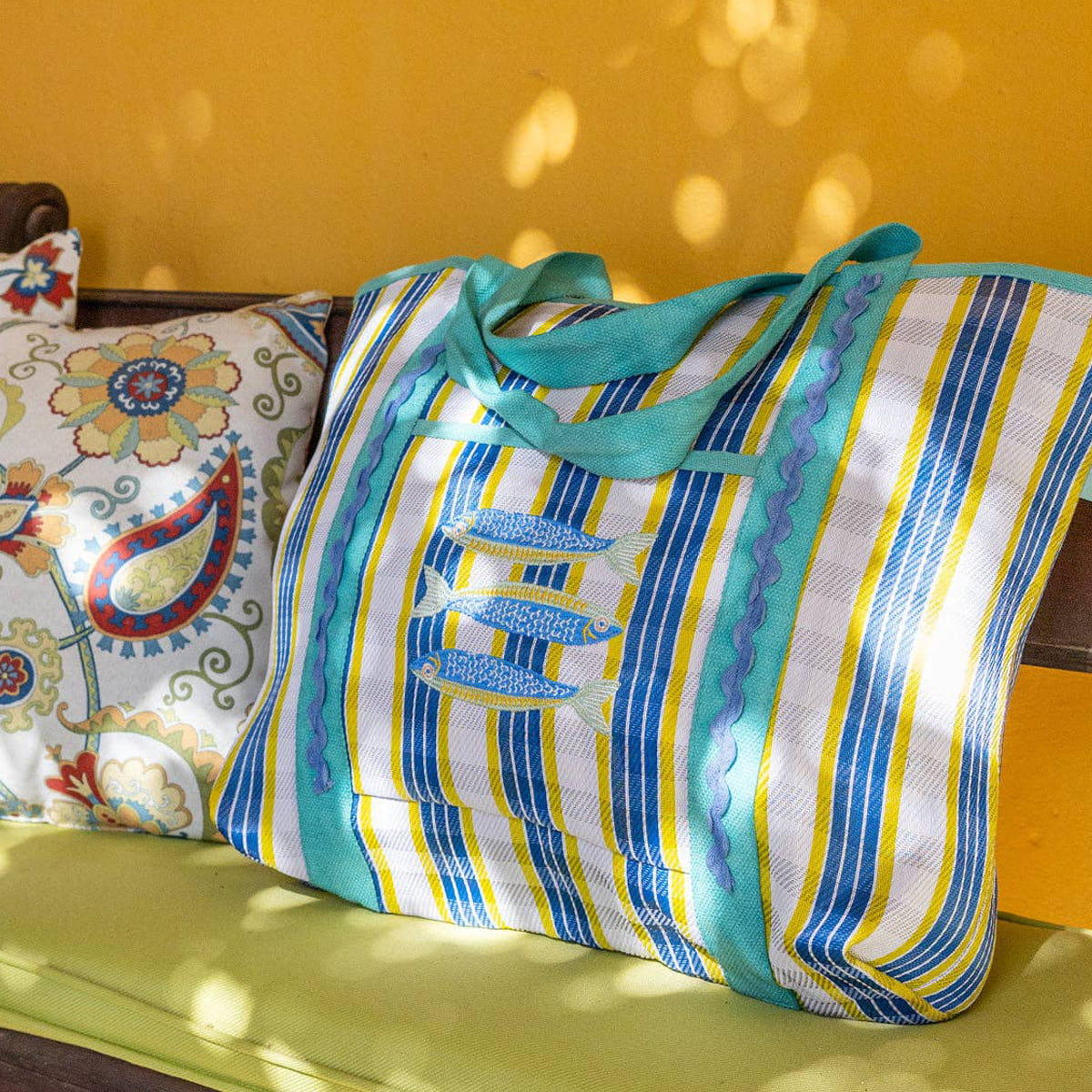Talking Tables Recycled Plastic Sardine Fish Tote Bag (1 pc) - product shown on green chair.