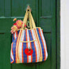 Talking Tables Recycled Plastic Tomato Tote Bag (1 pc) - product shown hanging from door handle.