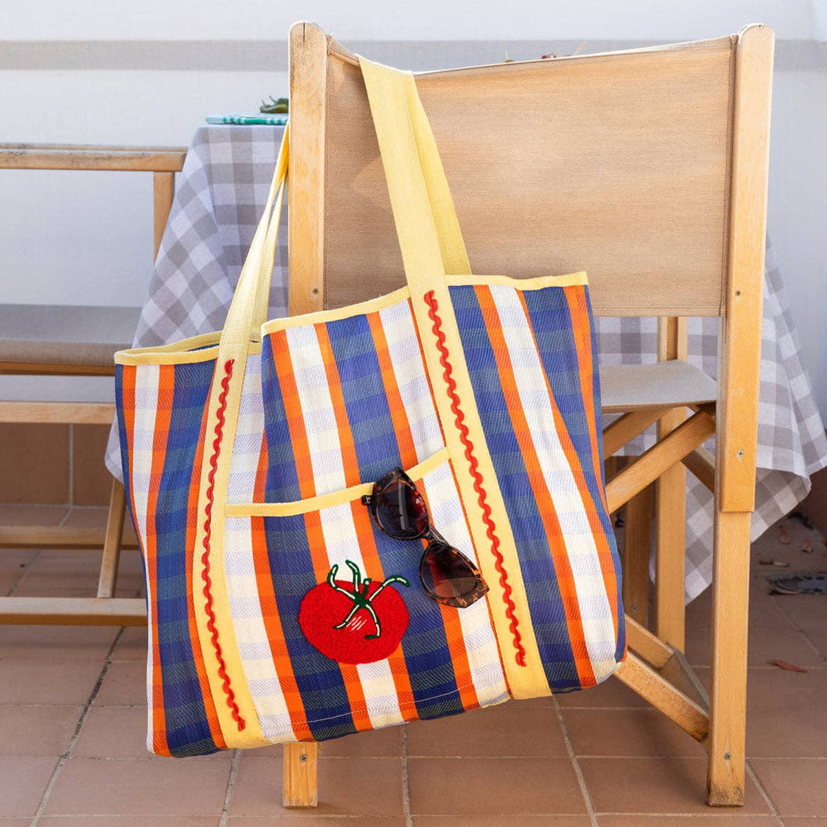 Talking Tables Recycled Plastic Tomato Tote Bag (1 pc) - product shown hanging from chair.