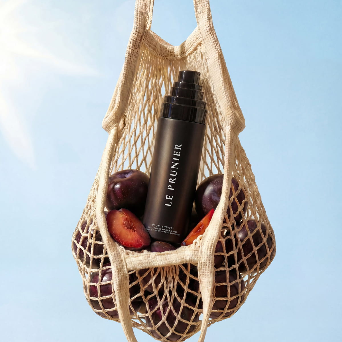 Le Prunier Plum Spritz (60 ml) - product shown in bag with plums.