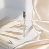 A. N. OTHER Ginger Tonic Eau de Parfum (7.5 ml) - product shown with fabric and feathers.