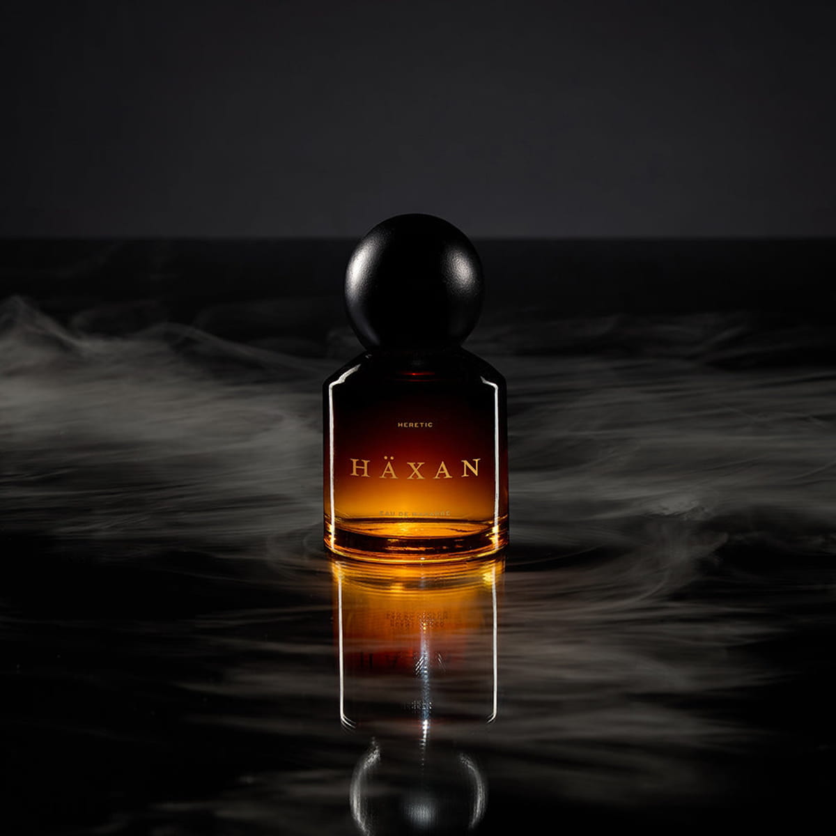 Heretic Parfum Haxan Eau de Macabre (30 ml) - product shown with smoke around it.