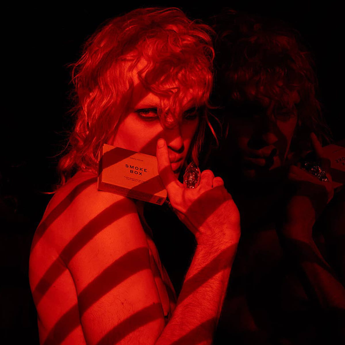 Heretic Parfum Smoke Box Eau de Parfum (5 x 2 ml) - product shown being held by model. 