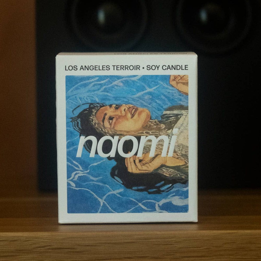 Naomi Los Angeles Terroir Candle (283 g) - product shown on wooden counter top. 
