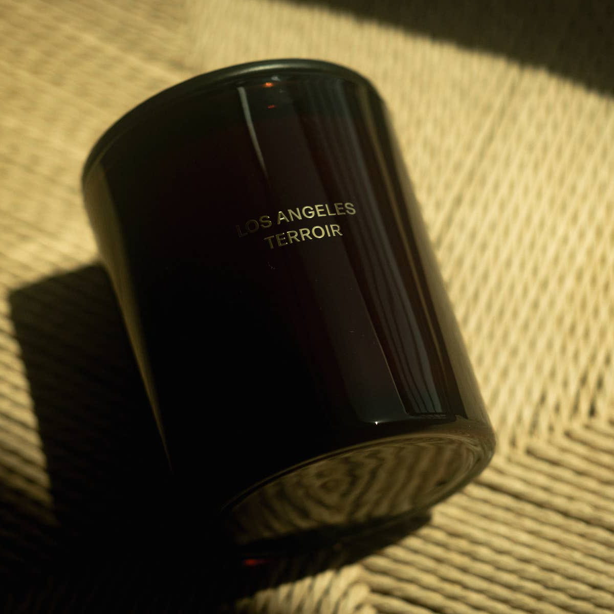 Naomi Los Angeles Terroir Candle (283 g) - product shown on fabric.