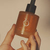 Mari Ostara All-Over Oil (50 ml) - product shown being held on white background.