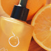 Mari Ostara All-Over Oil (50 ml) - product shown surrounded by oranges.