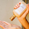 14th Night The Nourishing Shampoo (240 ml) - product shown being poured into hand.