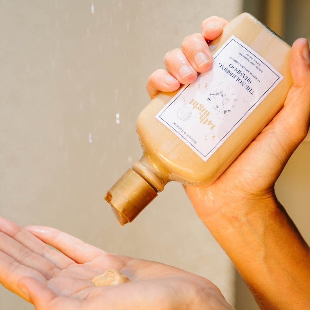 14th Night The Nourishing Shampoo (240 ml) - product shown being poured into hand.