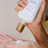 14th Night The Nourishing Conditioner (240 ml) - product shown being poured into hand.