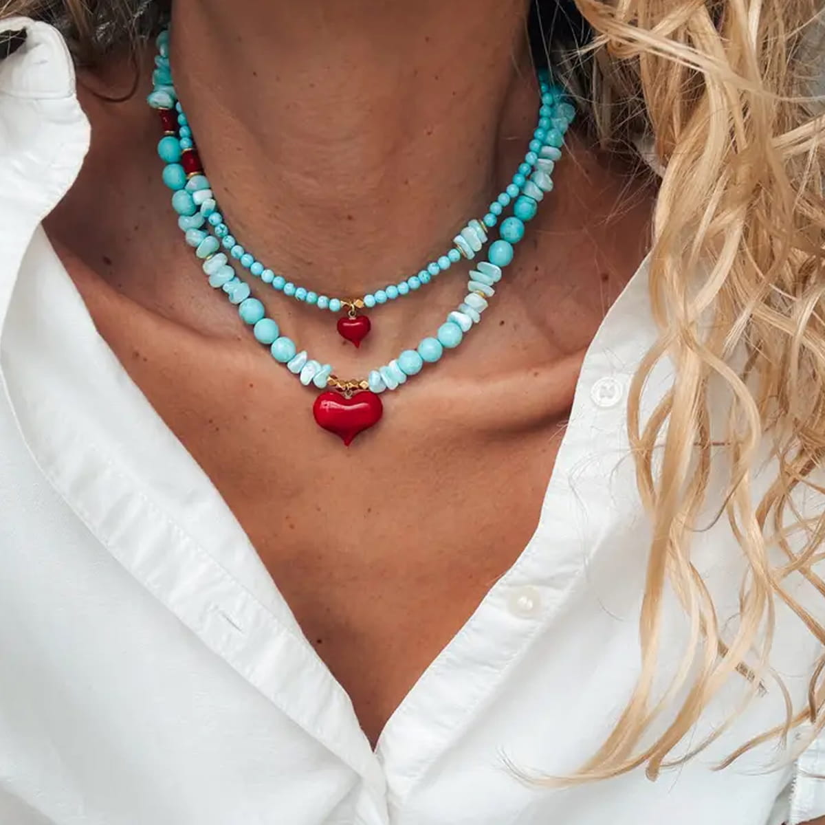 Close u of model wearing Goupi Turquoise Bead Necklace in Big Heart and Small Heart shown layered (each sold separately)