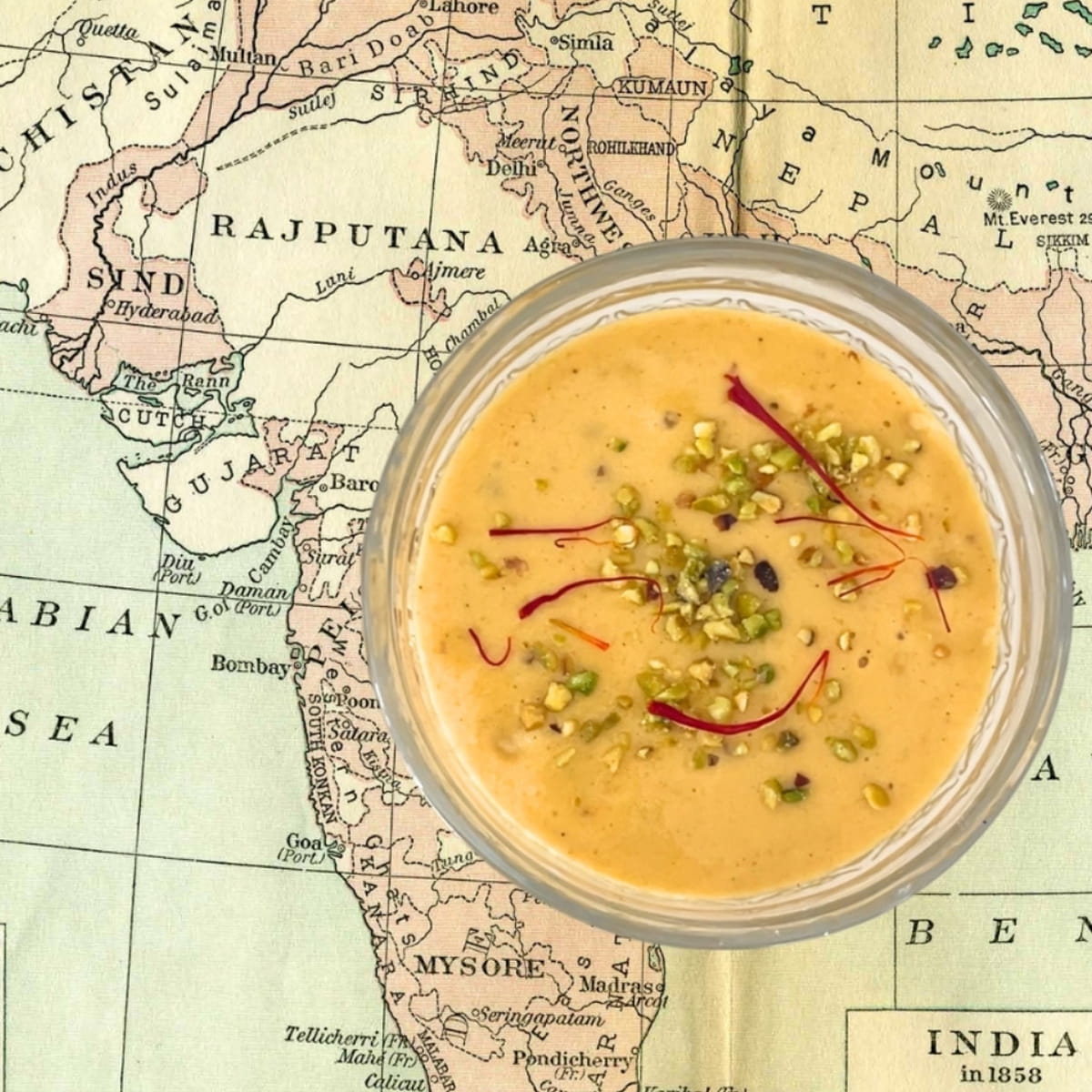 Top view of Chand & Radha Mango Ayurvedic Functional Latte Blend (210 g), set against a vintage map of India and surrounding regions.