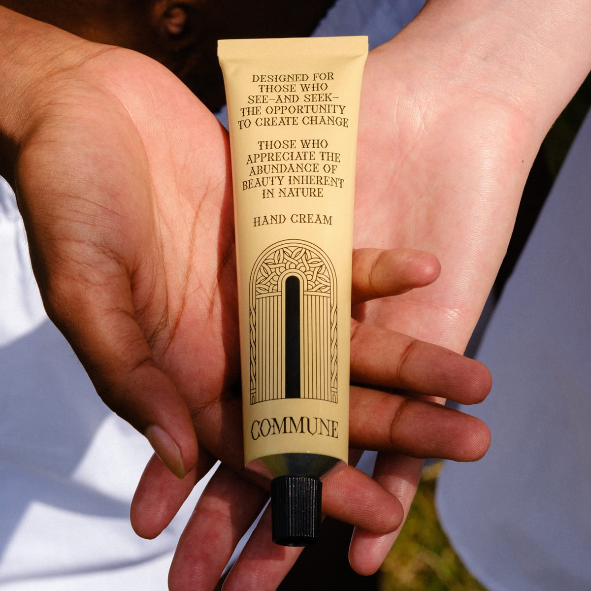 Close up of hands holding Commune Seymour Hand Cream (75 g)