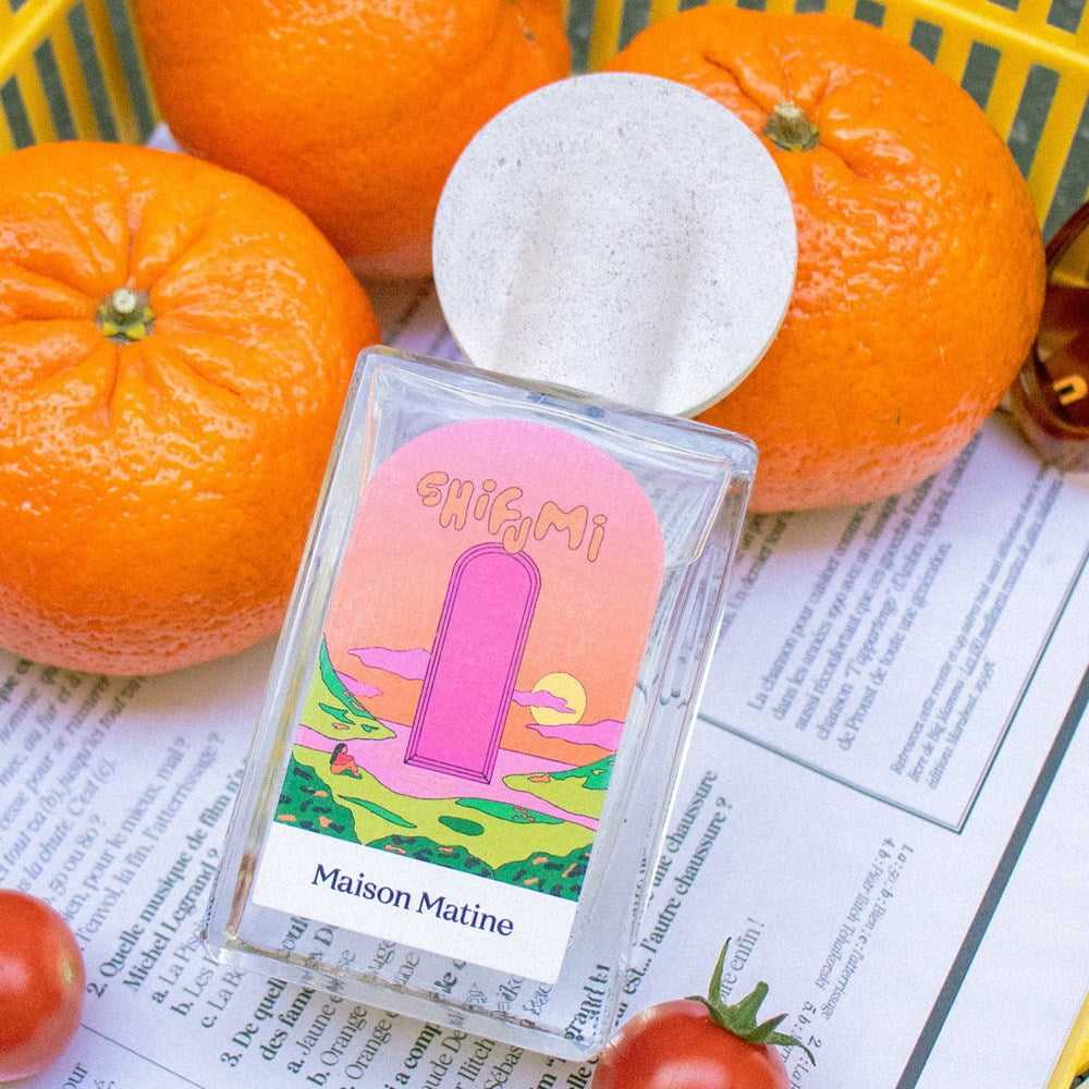Lifestyle shot, close up of Maison Matine Shifumi Eau de Parfum (100 ml) with oranges in the background