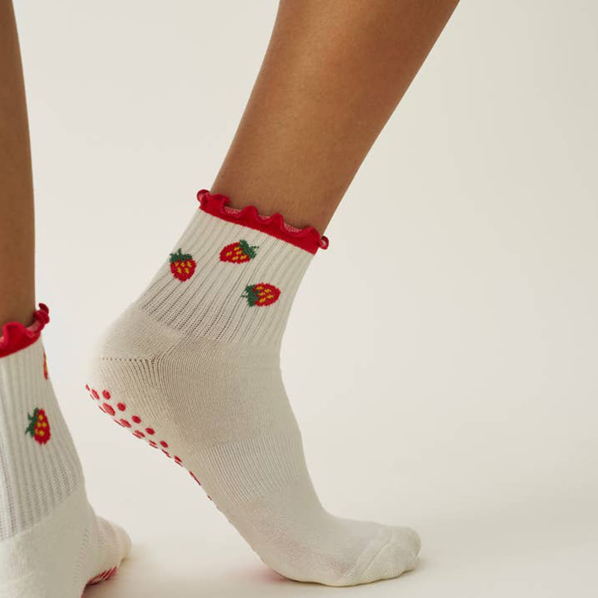 Close up of model wearing Effortless Club Strawberry Ruffle Grip Socks (1 pair)
