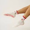 Model wearing Effortless Club Strawberry Ruffle Grip Socks (1 pair)