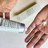 Mayron’s Goods Hands Softening Hand Cream (64 g) - product shown being applied to hands.
